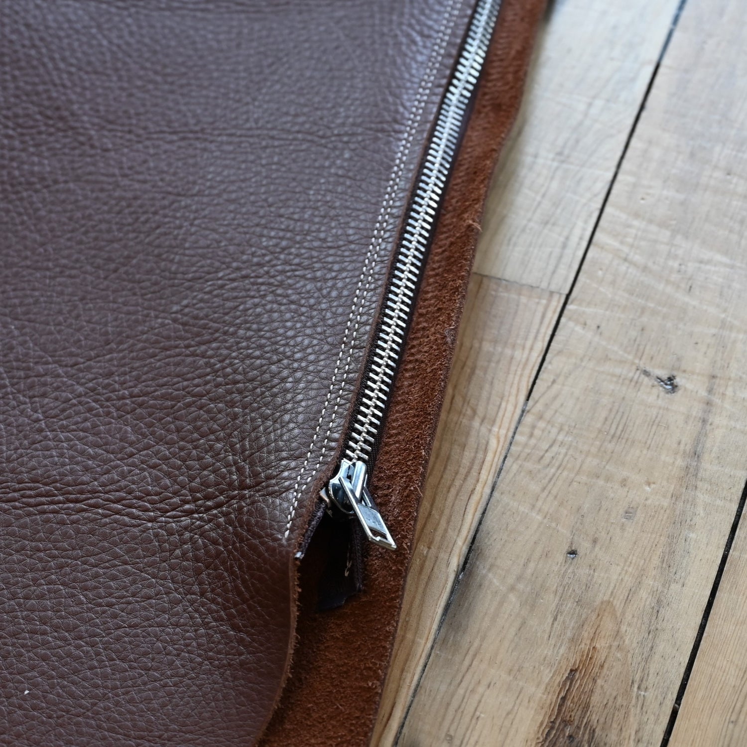 View of Weaver Shotgun Full Grain Chaps in brown oil-tanned leather with adjustable closures.