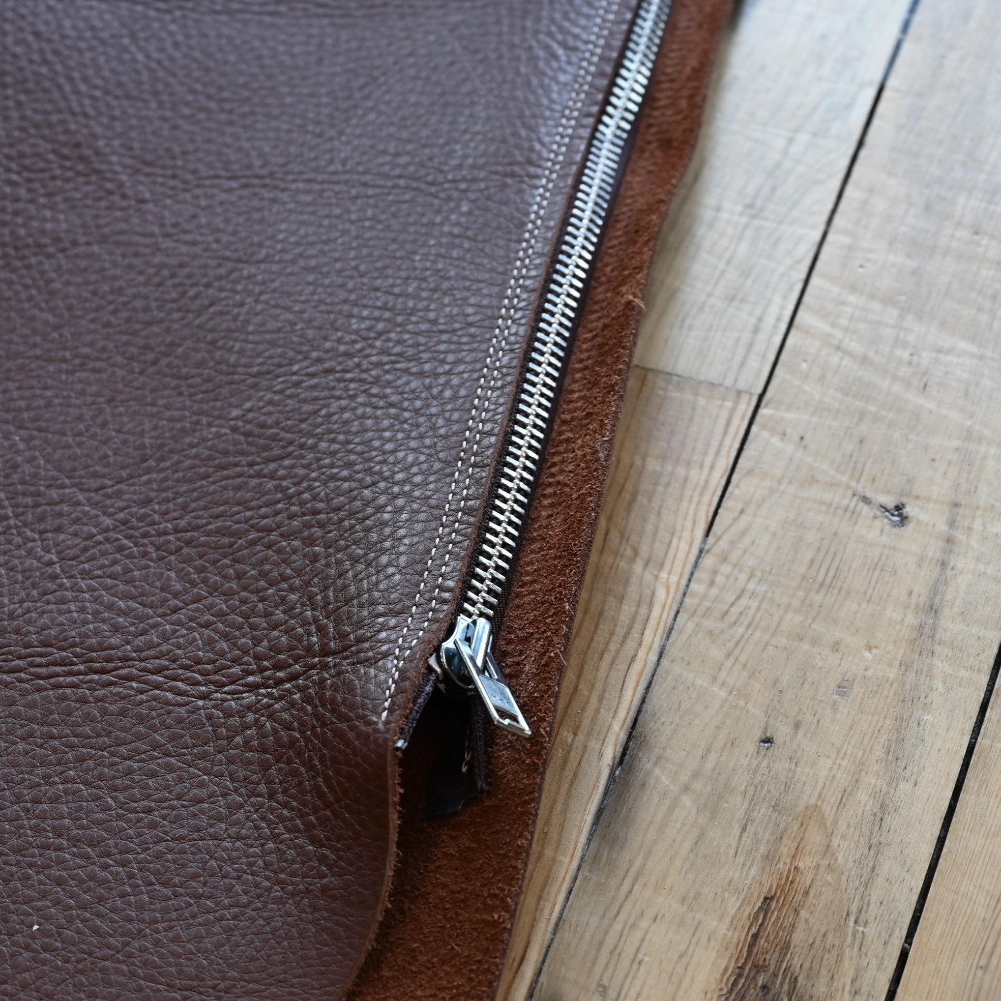 View of Weaver Shotgun Full Grain Chaps in brown oil-tanned leather with adjustable closures.