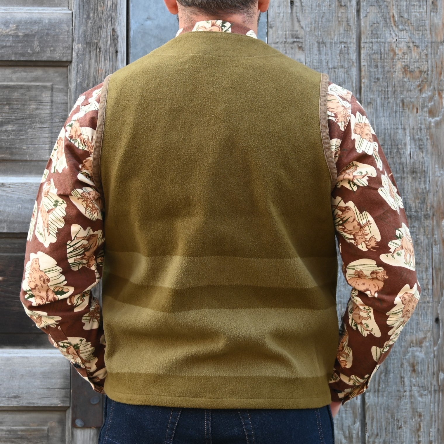 View of Filson Beartooth Cruiser Vest in Marsh Olive Blanket Stripe featuring snap-close front and reinforced pockets