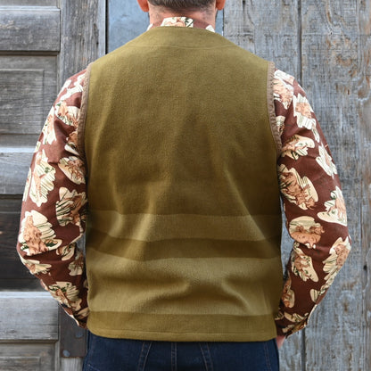 View of Filson Beartooth Cruiser Vest in Marsh Olive Blanket Stripe featuring snap-close front and reinforced pockets